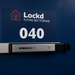 Storage unit door with PTI ProEdge smart lock installed, branded with Lockd Future Self Storage.